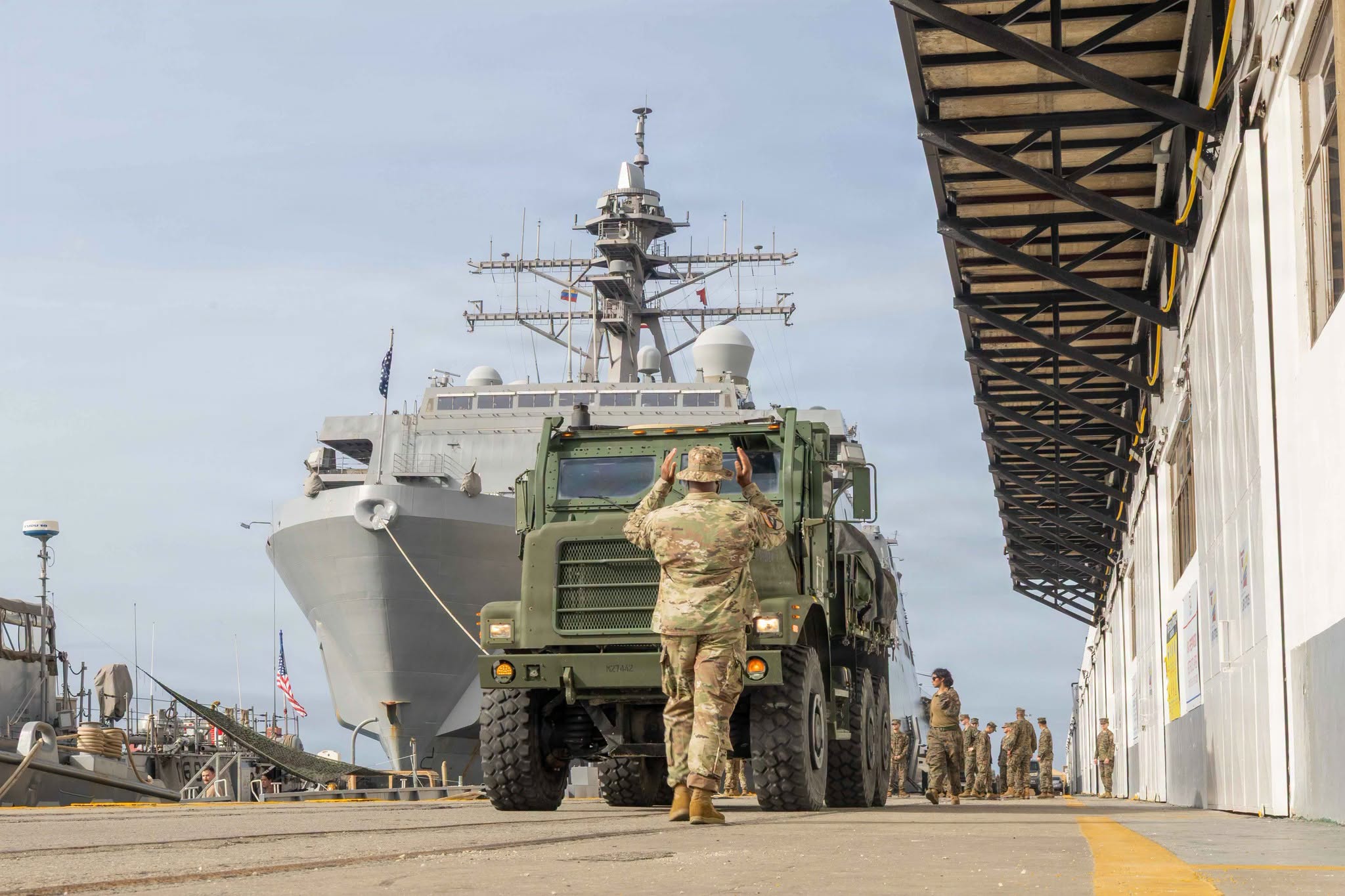 Marine Directing Military Vehicle During Port Operations
